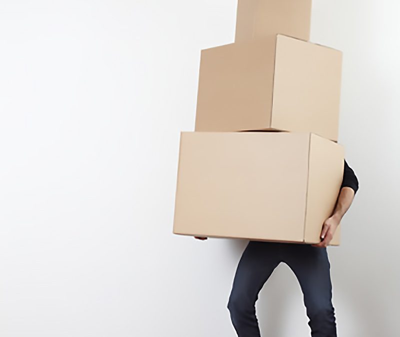 man-lifting-cardboard-boxes-in-apartment-moving-day-800